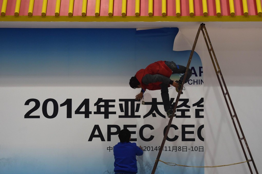 Workers prepare for Apec in Beijing. Taiwan will be represented at the summit by former vice-president Vincent Siew. Photo: AFP