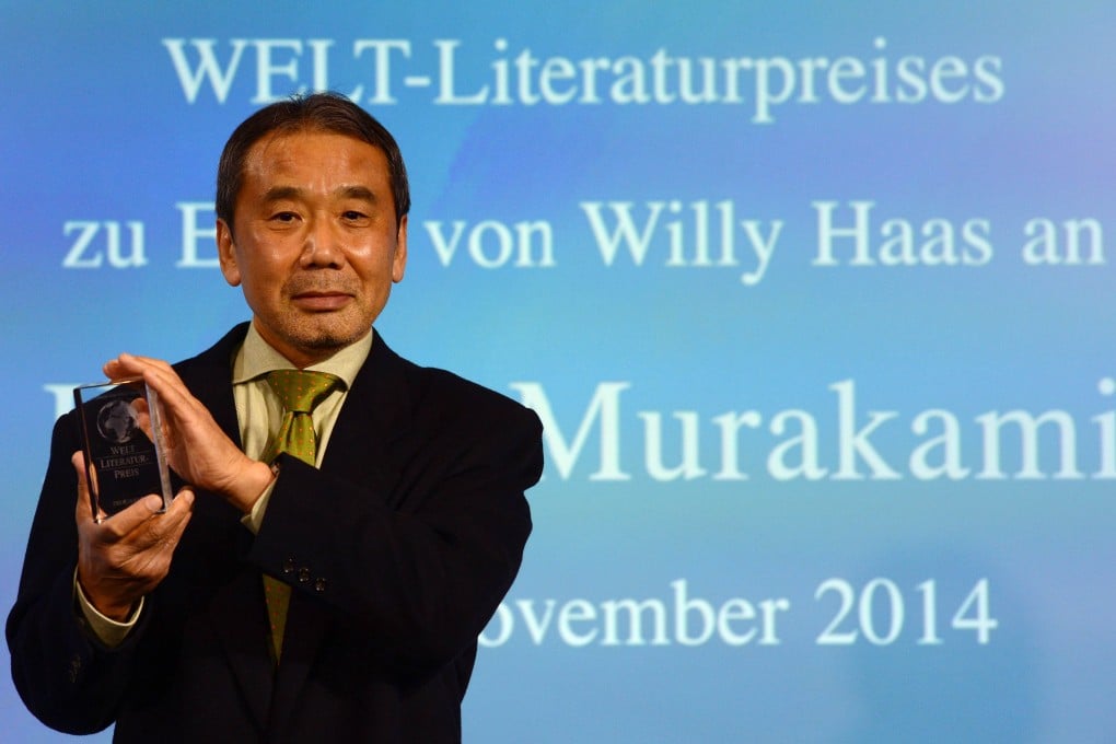 Haruki Murakami poses with his trophy for Germany's Welt Literature Prize in Berlin on Friday. Photo: AFP