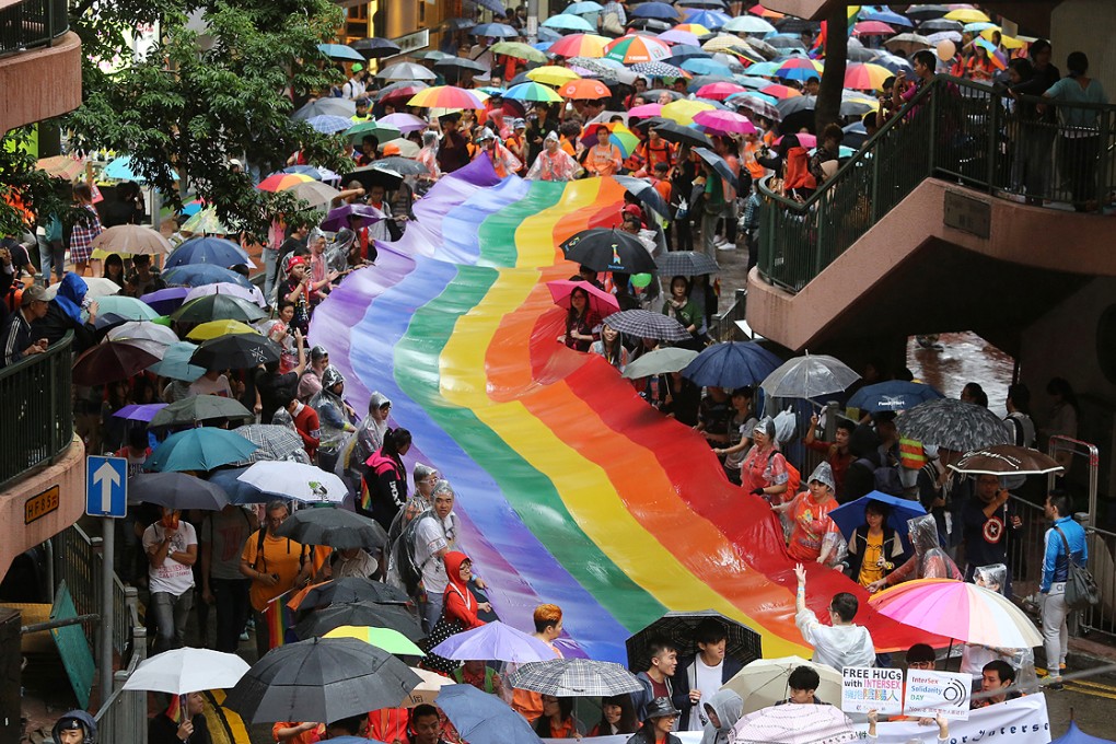 Participants carry a rainbow flag in Causeway Bay as part of the gay pride parade. Photo: Sam Tsang