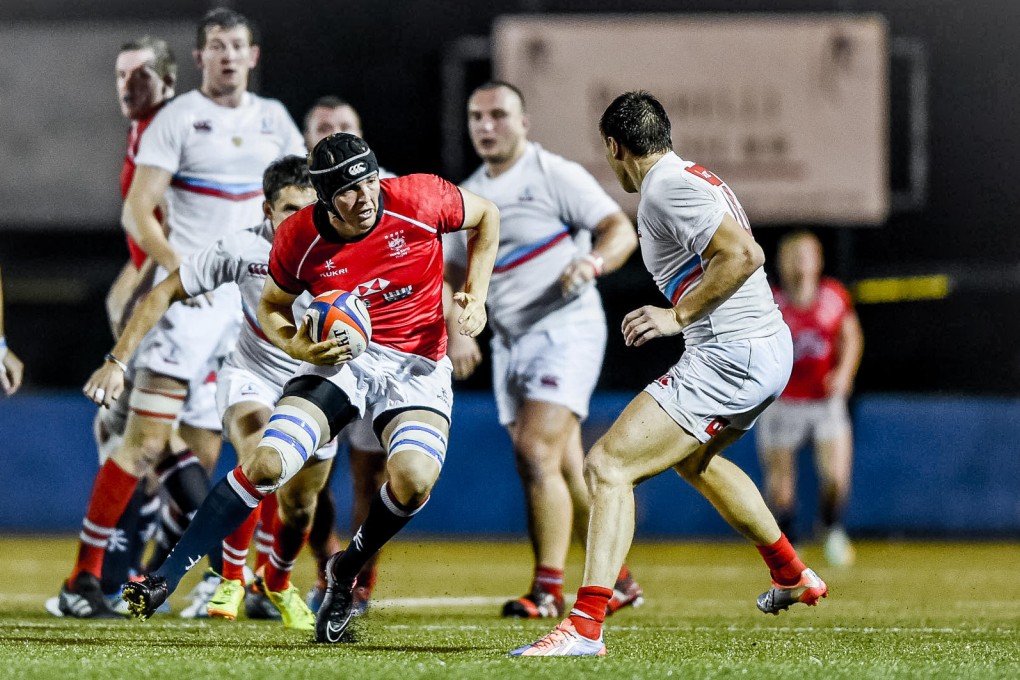 Hong Kong’s Bill Brant carries the ball into battle against Russia at King's Park on Saturday. Photos: HKRFU
