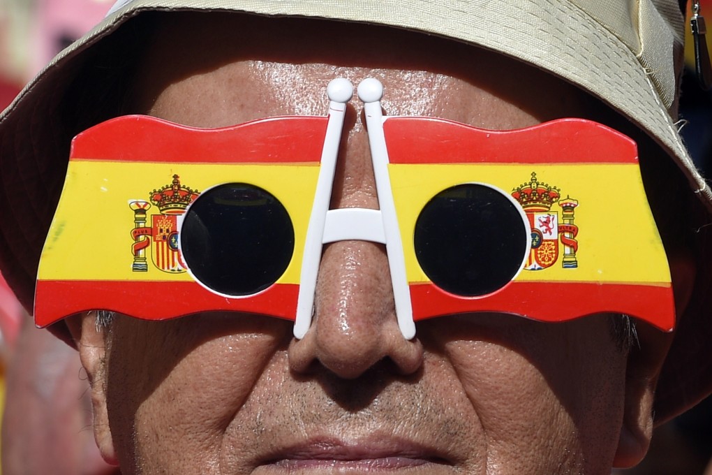 An anti-independentist Catalan wearing glasses bearing colours of the Spanish flag takes part in a demonstration for the unity of Spain. Photo: AFP