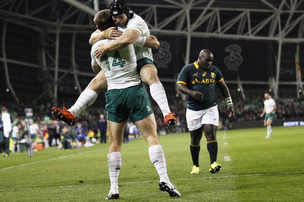 Ireland's Tommy Bowe is embraced by team-mate Richardt Strauss after scoring against South Africa in Dublin on Saturday. Photo: AP