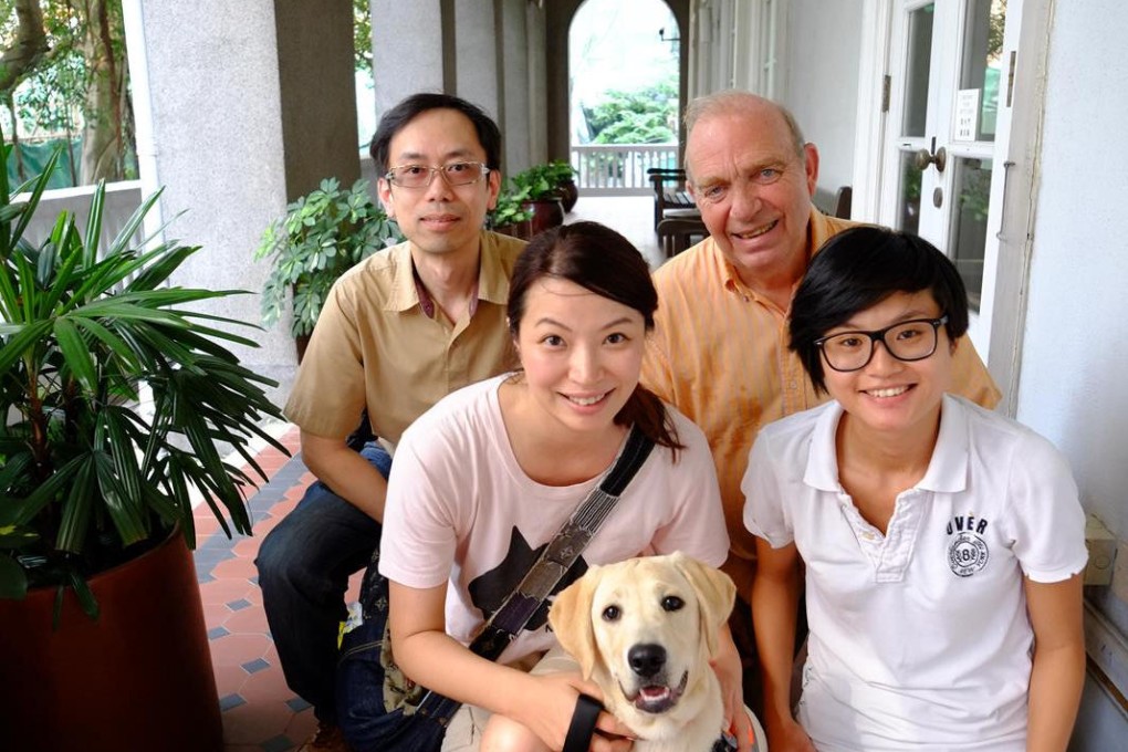 Lily Lam and labrador Bella with Hong Kong Guide Dogs Association staff (from left) Eddie Lee, Brian Francis and Fish Chan.