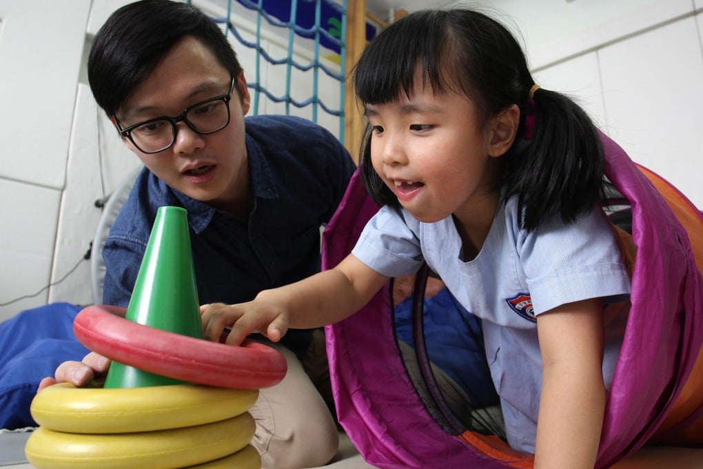 Occupational therapist Steve Chan (left) and six-year-old Sasa Lao at the Rainbow Project's learning centre on Sai Yuen Lane in Western. Photo: Dickson Lee