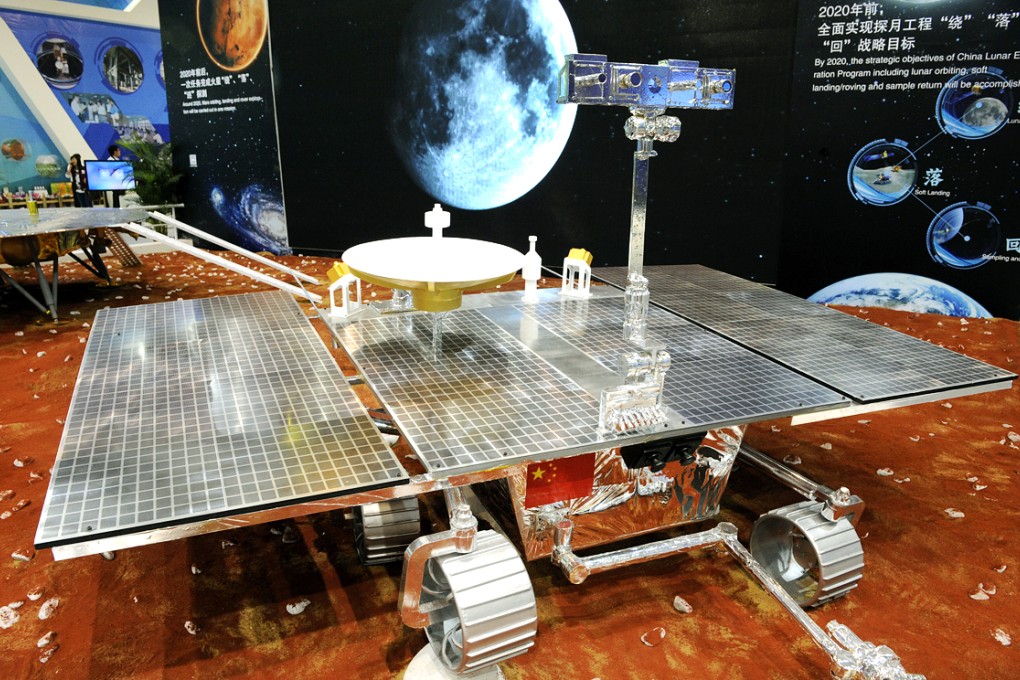 Visitors look at a prototype model of a Mars rover on display at the China International Industry Fair in Shanghai. Photo: Xinhua