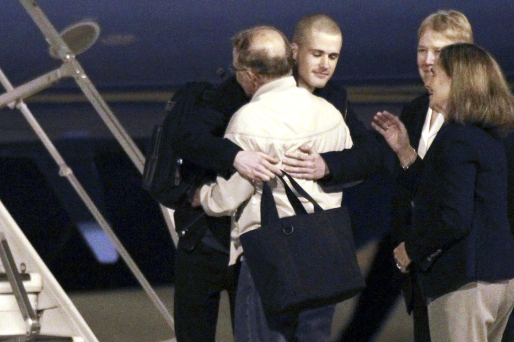 Matthew Miller (centre), one of two detainees who arrived home to the United States. Photo: Reuters