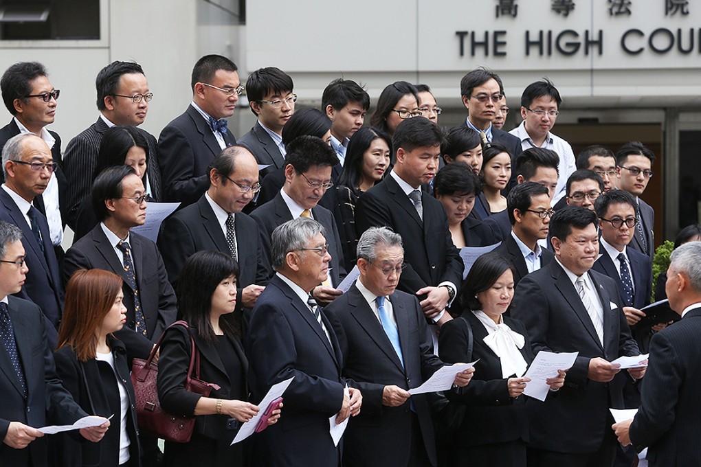 Lawyers stand in silence outside the High Court to condemn those ignoring temporary court injunctions taken out to stop people blocking roads as part of the ongoing Occupy Central civil disobedience movement on November 3. Photo: Sam Tsang