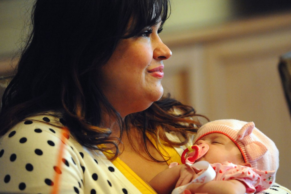 Ruby Graupera-Cassimiro holds her newborn daughter, Taily. Photo: MCT