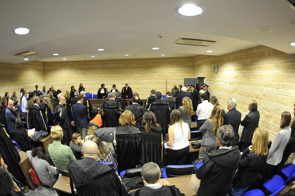 Judge Fabrizia Ida Francabandera reads the appeal sentence clearing seven experts charged with failing to warn residents of the risk of the L'Aquila earthquake. Photo: AP