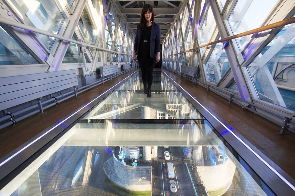 A woman walks across the new glass viewing platform. Photo: AFP