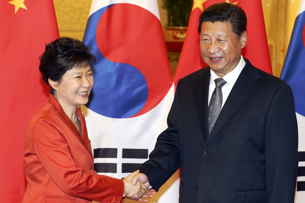Xi Jinping shakes on the deal with Park Geun-hye. Photo: EPA