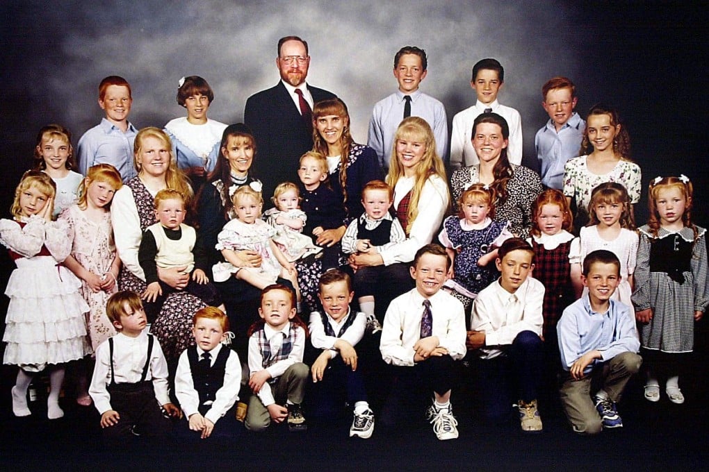 Utah polygamist Tom Green poses with his five wives and some of his 29 children in 2000, the year before he was convicted. Photo: AFP