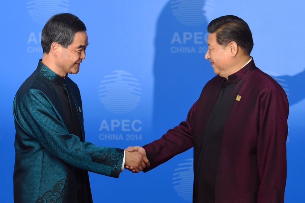 Hong Kong's Chief Executive Leung Chun-ying (left) is welcomed by Chinese President Xi Jinping. Photo: AFP