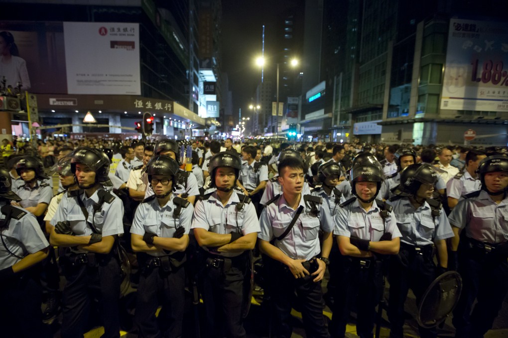 Police stand guard at the occupied area in Mong Kok. Photo: AP