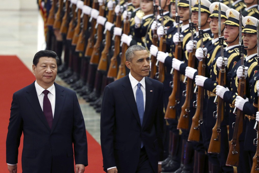 Chinese President Xi Jinping (left) and US President Barack Obama review honour guards during a welcoming ceremony at the Great Hall of the People in Beijing. Photo: EPA
