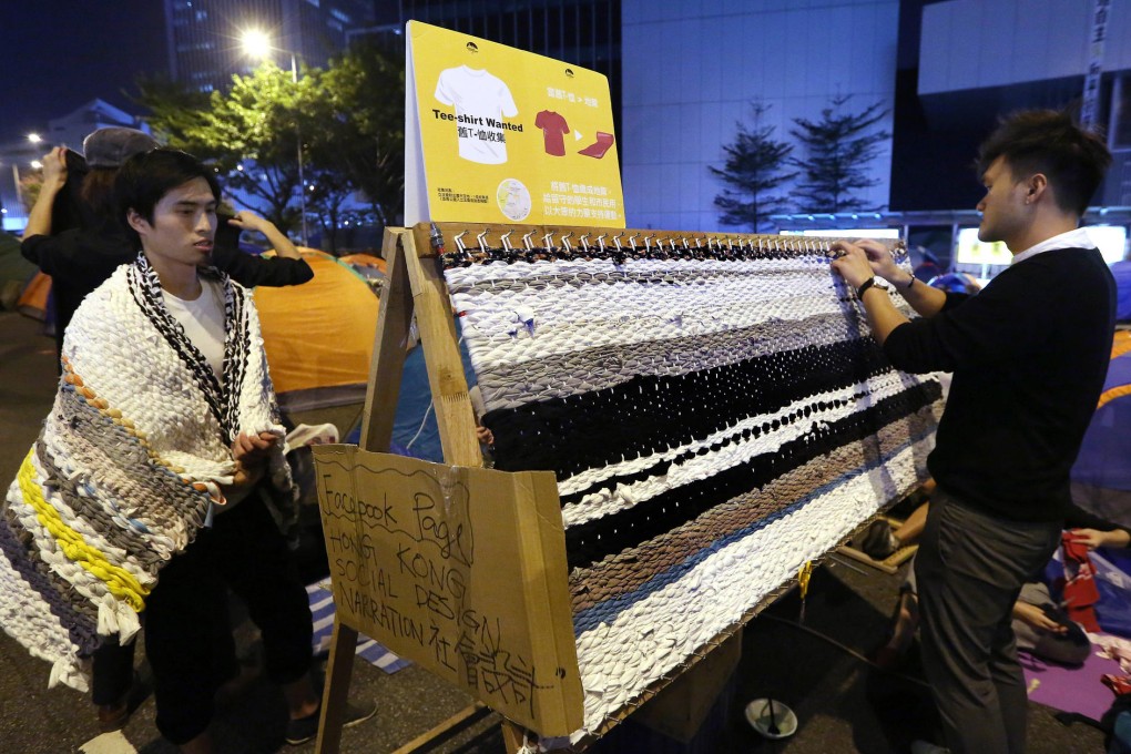 Some of the team of designers work on turning the donated T-shirts into comfortable mats for protesters spending their nights on the streets of Admiralty. Photo: Sam Tsang