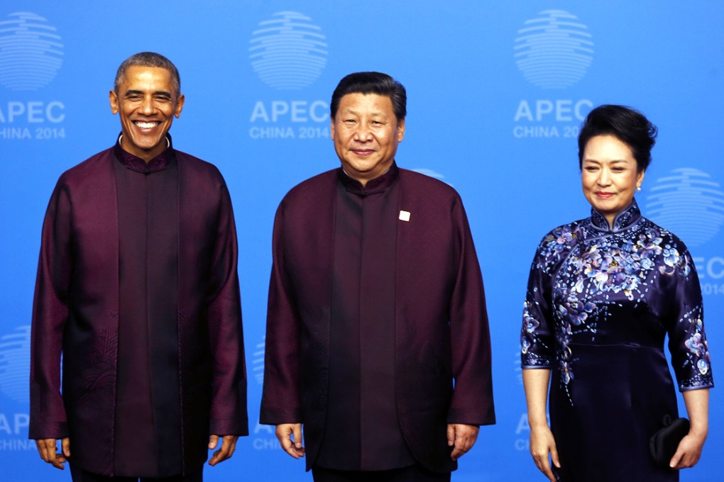 US President Barack Obama (from left) smiles as he poses in his  burgundy suit with Chinese President Xi Jinping and his wife Peng Liyuan, upon his arrival for the dinner in Beijing on Monday. Photo: AP