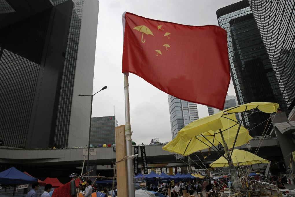 A flag with the image of an umbrella flies in an occupied area outside the government headquarters in Admiralty. Photo: AP