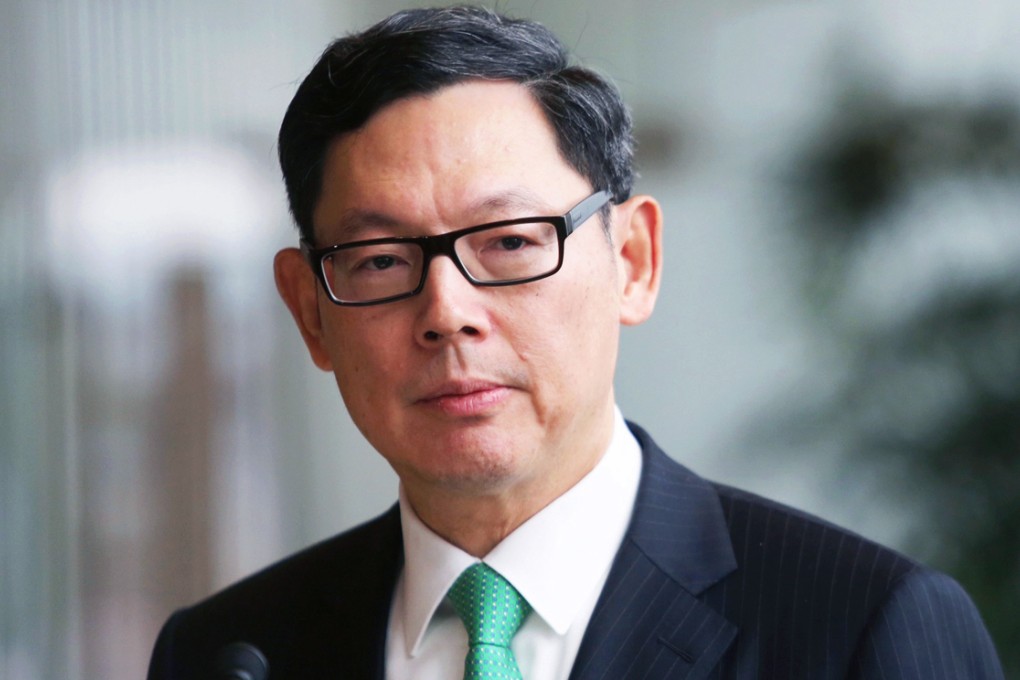HKMA chief Norman Chan says the daily cap to exchange Hong Kong dollars for yuan will be lifted starting on Monday when the Shanghai-Hong Kong Stock Connect scheme is launched. Photo: Sam Tsang