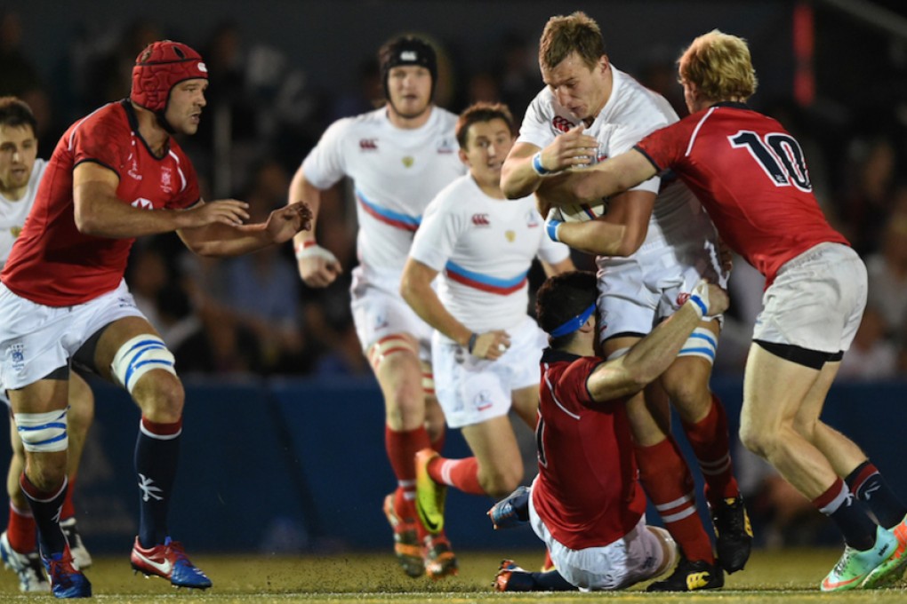 Hong Kong’s 15s captain Nick Hewson (left) and sevens skipper Jamie Hood (number 10) move in to close down the Russian attack during the first test at King’s Park. Photo: HKRFU