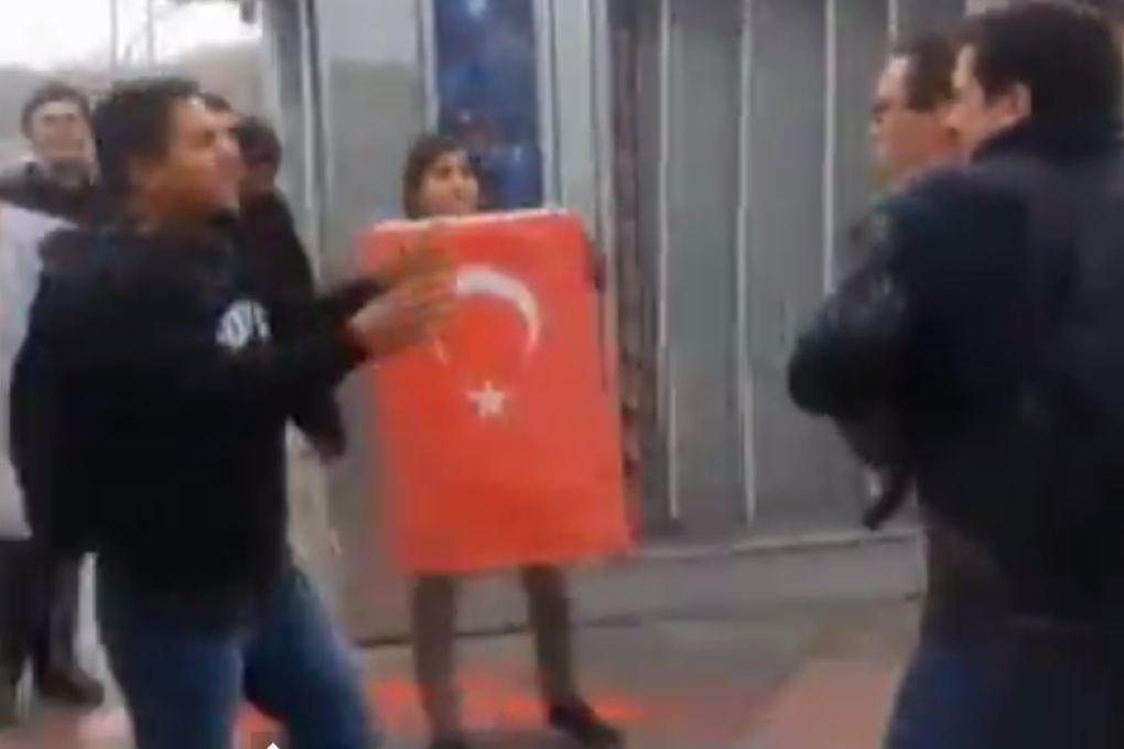 Protesters threw red paint at the sailors and briefly succeeded in putting white sacks over their heads. Photo: SCMP