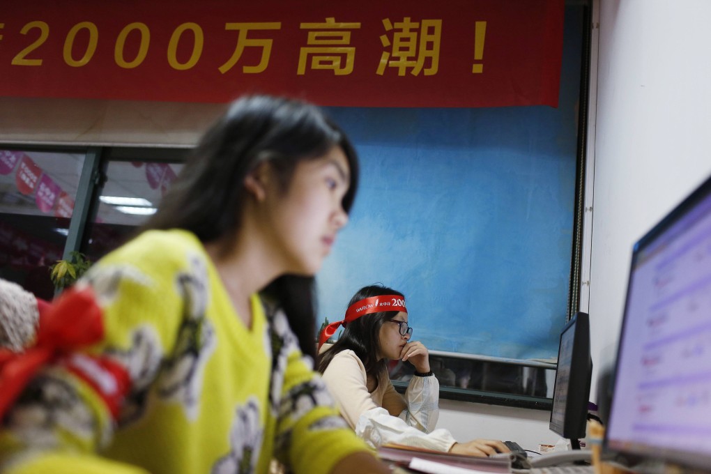 Employees of Alibaba's Tmall handle sales on Singles' Day, November 11. E-commerce giant Alibaba forged a deal with Cosco to handle the quickly growing cross-border merchandise business in Guangzhou. Photo: Reuters