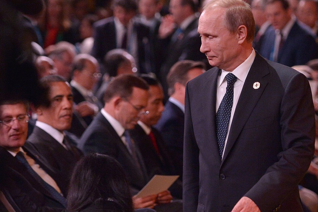 Russia's President Vladimir Putin (right) arrives as Canada's Prime Minister Stephen Harper and US President Barack Obama look on during the G20 Summit welcoming ceremony in Brisbane on Saturday. Photo: AFP
