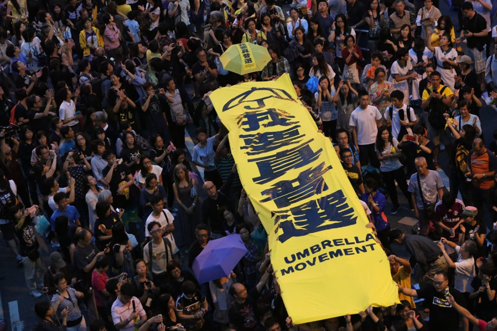 Protesters hold lights and banner saying "I want universal suffrage" in Admiralty during Occupy Central movement. Photo: Felix Wong