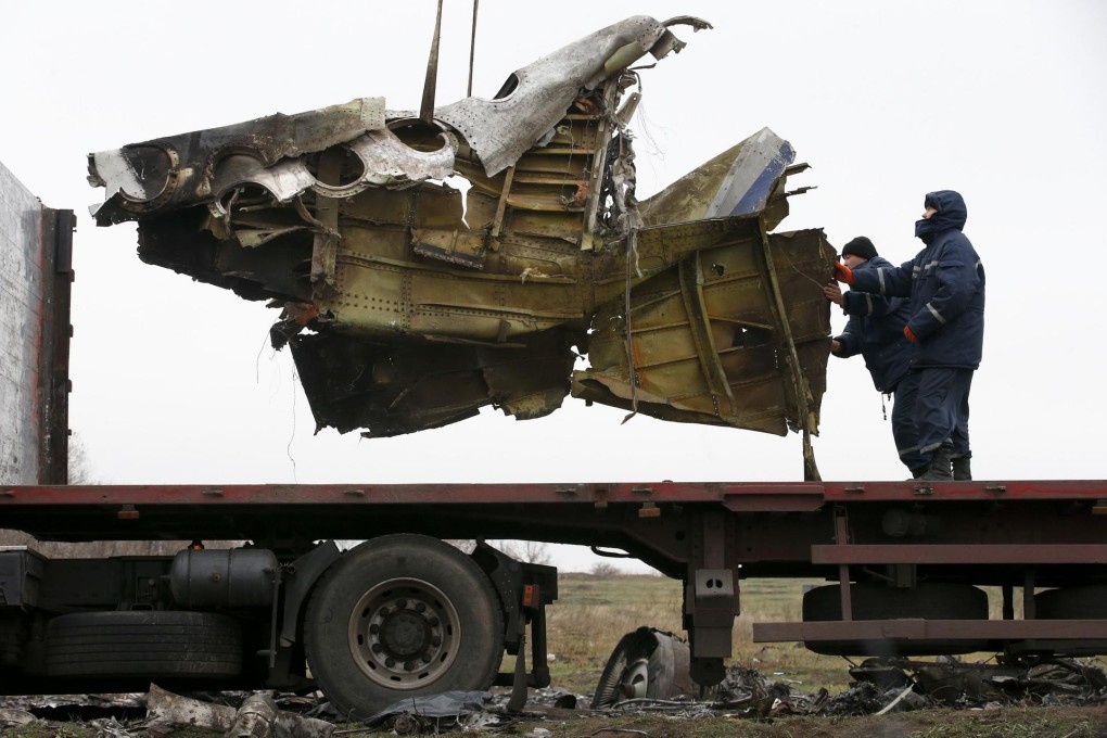 MH17 wreckage is loaded on to a truck yesterday. Photo: Reuters