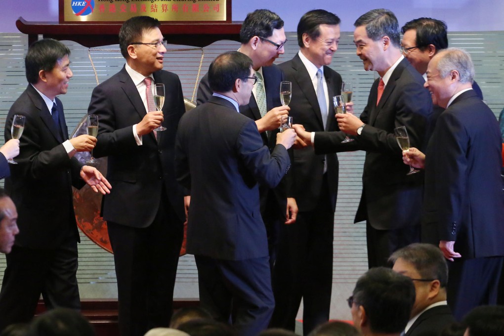 Executives from the Hong Kong and Shanghai bourses and government officials toast the launch of the stock through train. Photo: Felix Wong