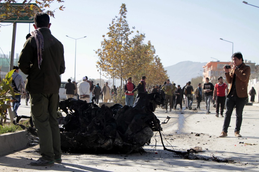 Afghan security officials inspect the scene of a suicide car bomb attack that targeted a female legislator Shukria Barakzai in Kabul. Photo: EPA