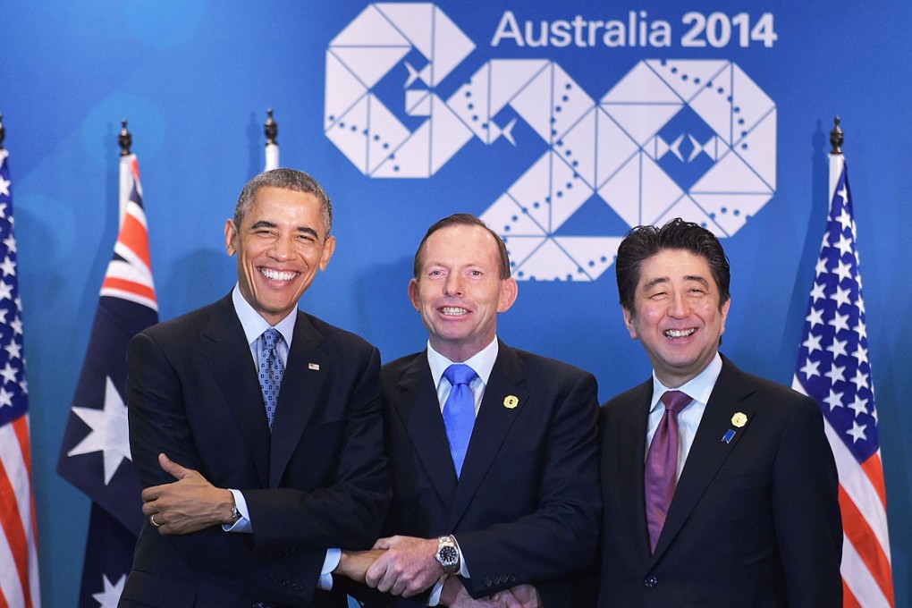 Barack Obama, Tony Abbott and Shinzo Abe seal a deal to strengthen military ties between their countries. Photo: AFP