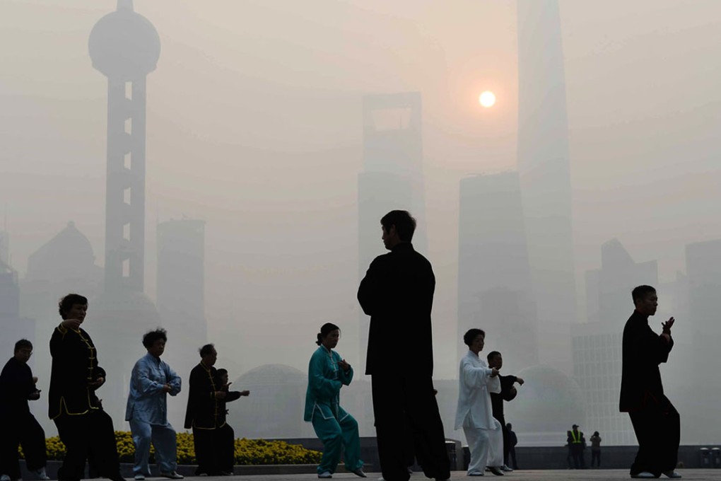 Shanghai residents exercise on the Bund despite a yellow alert for pollution. China last week made an historic agreement to control its greenhouse gas emissions. Photo: AFP