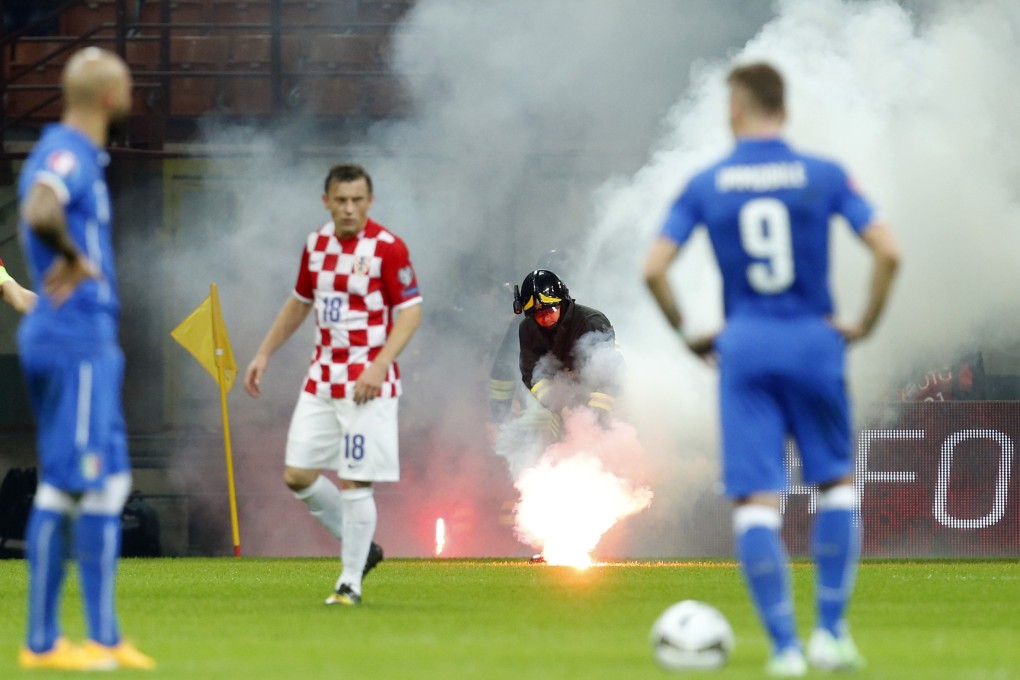 Italy's game with Croatia was twice halted after fans threw flares onto the pitch. Photo: Reuters