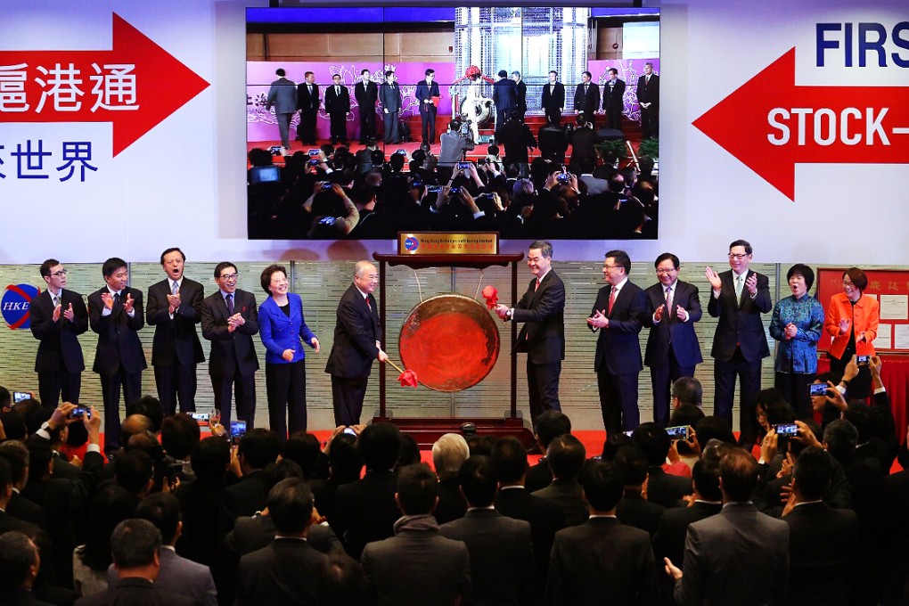 HKEx chairman Chow Chung-kong (left) and Chief Executive Leung Chun-ying launch the Stock Connect scheme with a gong. Photo: Felix Wong