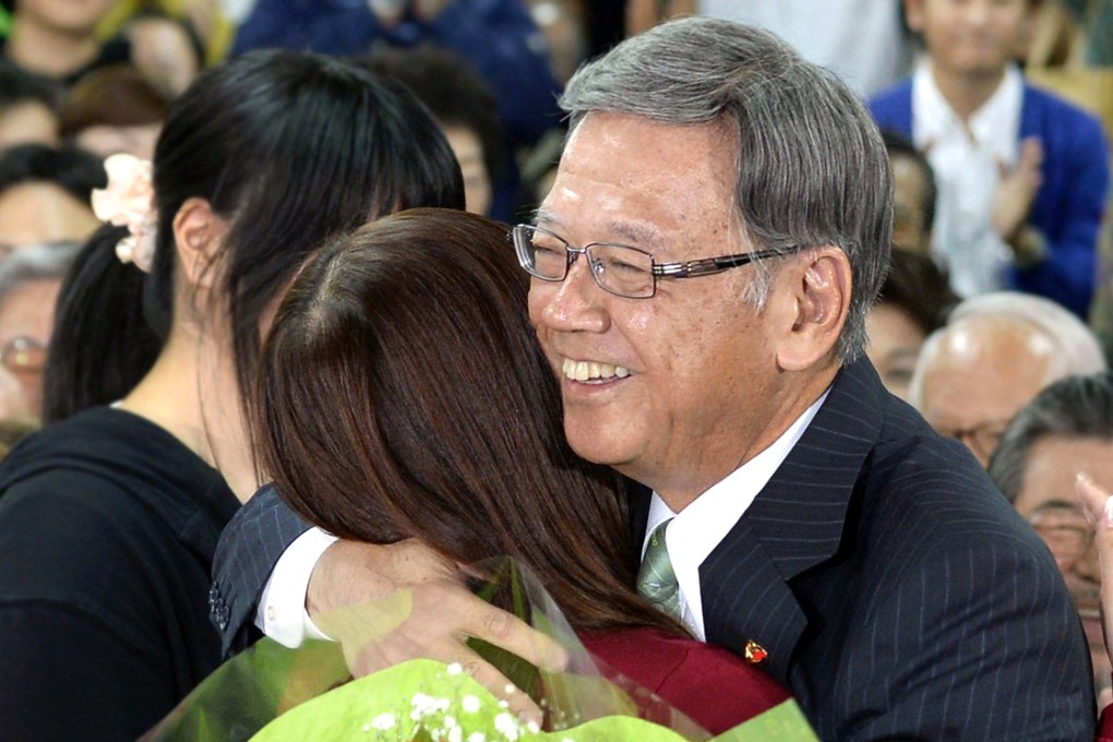 Takeshi Onaga hugs his daughter after the result. Photo: Reuters