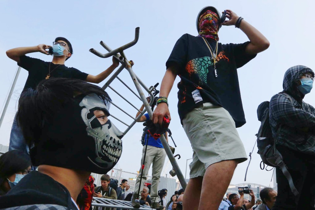 Protesters stand on the barricades. Photo: Sam Tsang