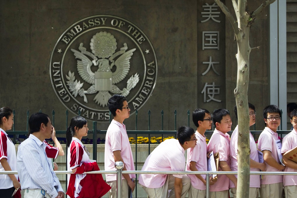 Chinese students wait outside the US embassy in Beijing for their visa application interviews. Photo: AP