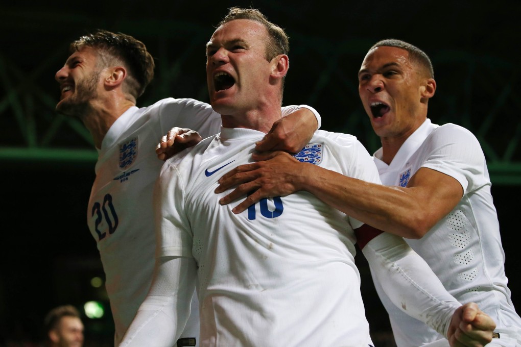 Wayne Rooney celebrates scoring England's second goal with Adam Lallana and Kieran Gibbs in the friendly against Scotland at Celtic Park in Glasgow. Photo: AFP