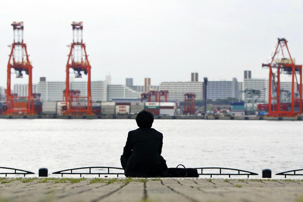 Prospects for the world economy may be as bleak as this businessman's view of a Tokyo port. Photo: Reuters