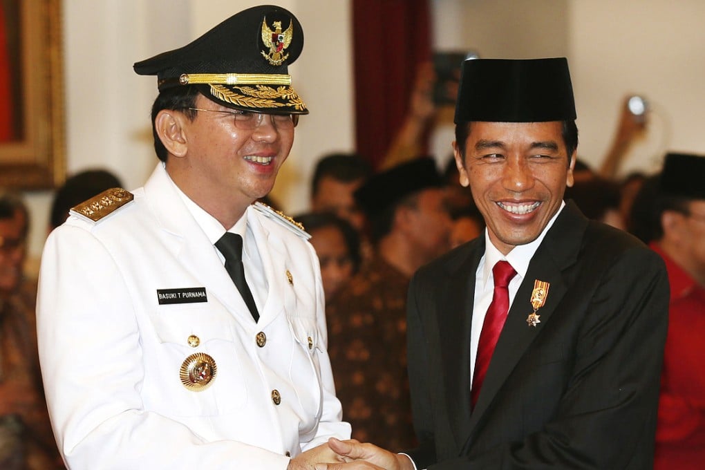 Basuki (left) is congratulated by President Widodo. Photo: AP