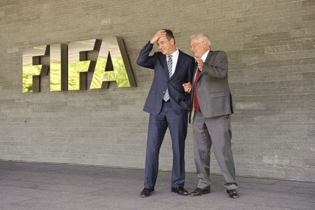 This file picture taken on July 27, 2012 shows Michael J Garcia (C), Chairman of the investigatory chamber of the FIFA Ethics Committee, and Hans-Joachim Eckert (R), Chairman of the adjudicatory chamber of the FIFA Ethics Committee posing for photographers after a press conference at FIFA headquarters in Zurich. Photo: AFP