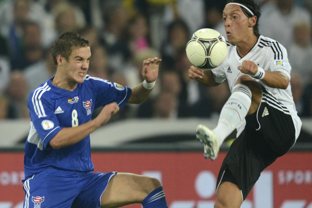 Germany's Mesut Ozil (right) donated his World Cup bonus to provide operations for 23 seriously ill children in Brazil. Photo: Reuters