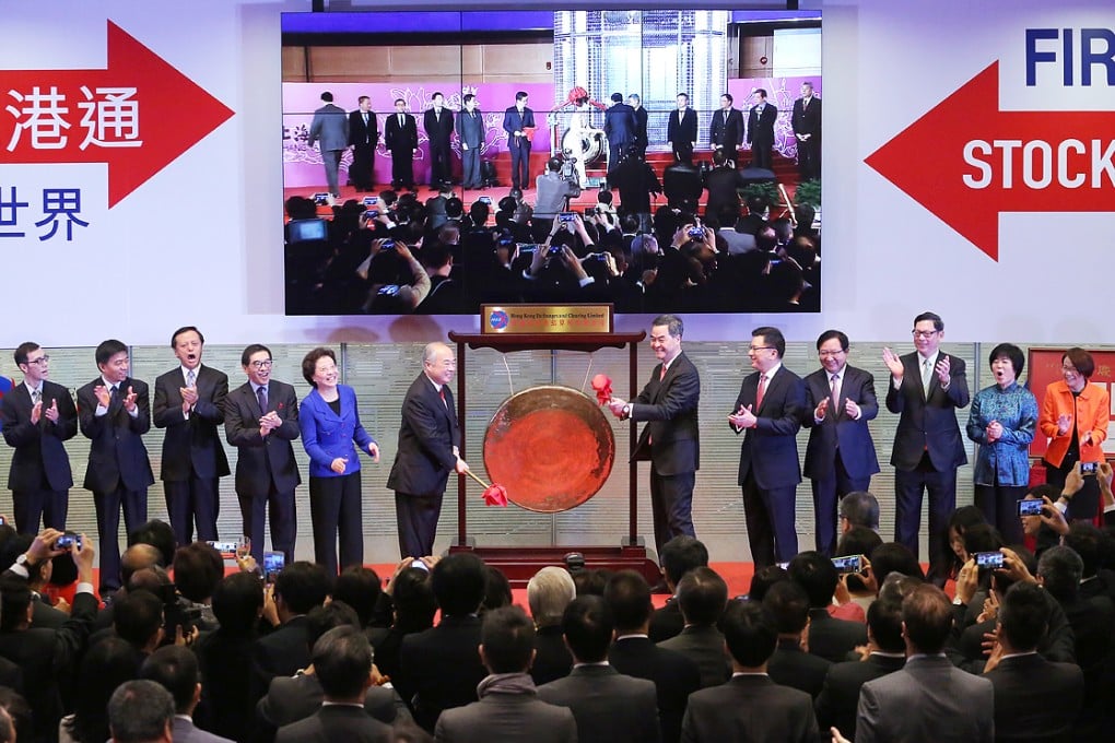 Hong Kong Exchanges and Clearing Limited chairman Chow Chung-kong and Leung Chun-ying beat a gong at the Stock Connect launch ceremony. HKEx chairman Chow Chung-kong has vowed to step up promotions across the border.