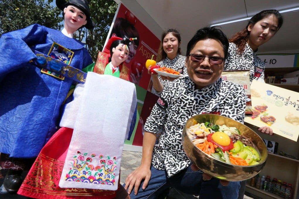 K-Food Fair vendors (from left) Woo Hwi-hyang, Lee Dong-yop and Lee Ha-young with some of their Korean food. Photo: Felix Wong