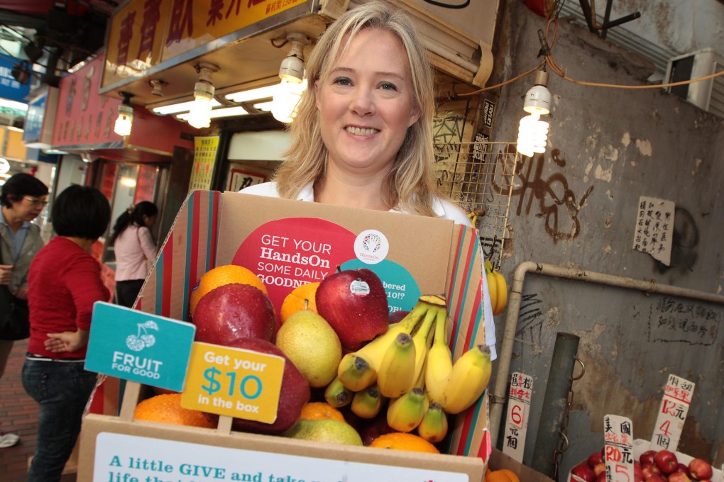 Caroline Sprod, executive director of HandsOn charity, with one of the fruit baskets being sold to help mentally disabled people. Photo: Bruce Yan