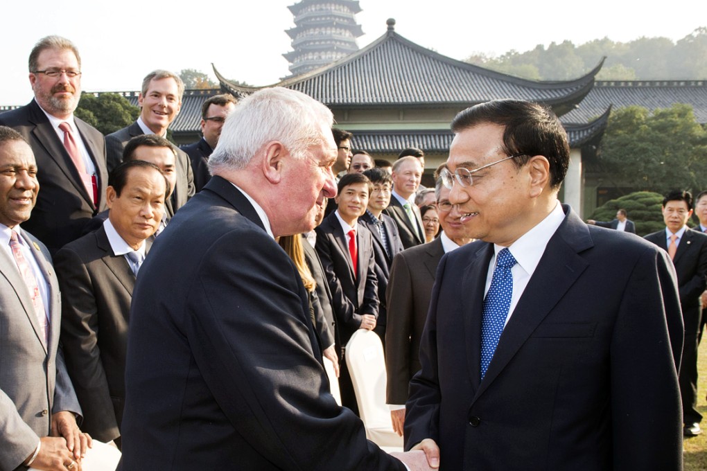 Premier Li Keqiang greets former Irish prime minister Bertie Ahern and others attending the conference in Zhejiang. Photo: Xinhua