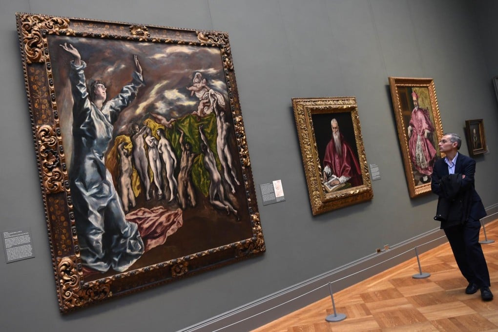 A man looks at paintings by El Greco at the Metropolitan Museum of Art's "El Greco in New York" exhibition.