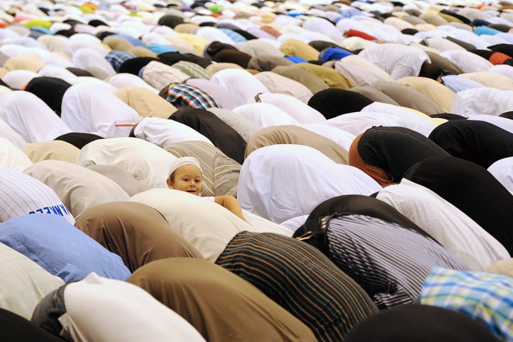 French Muslims pray in a hall of the Parc Chanot, in Marseille during celebrations of Eid al-Fitr which marks the end of the fasting month of Ramadan. Photo: AFP