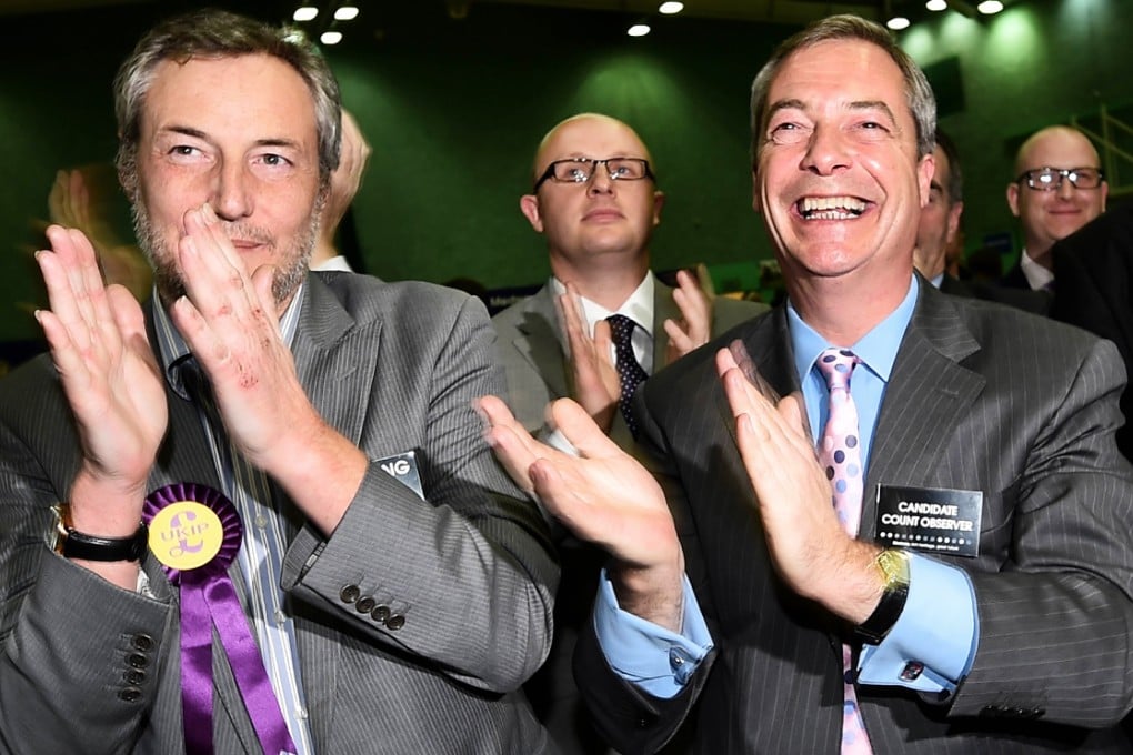 Ukip leader Nigel Farage (right) cheers as it is announced that his party's Mark Reckless had won the by-election. Photo: AFP